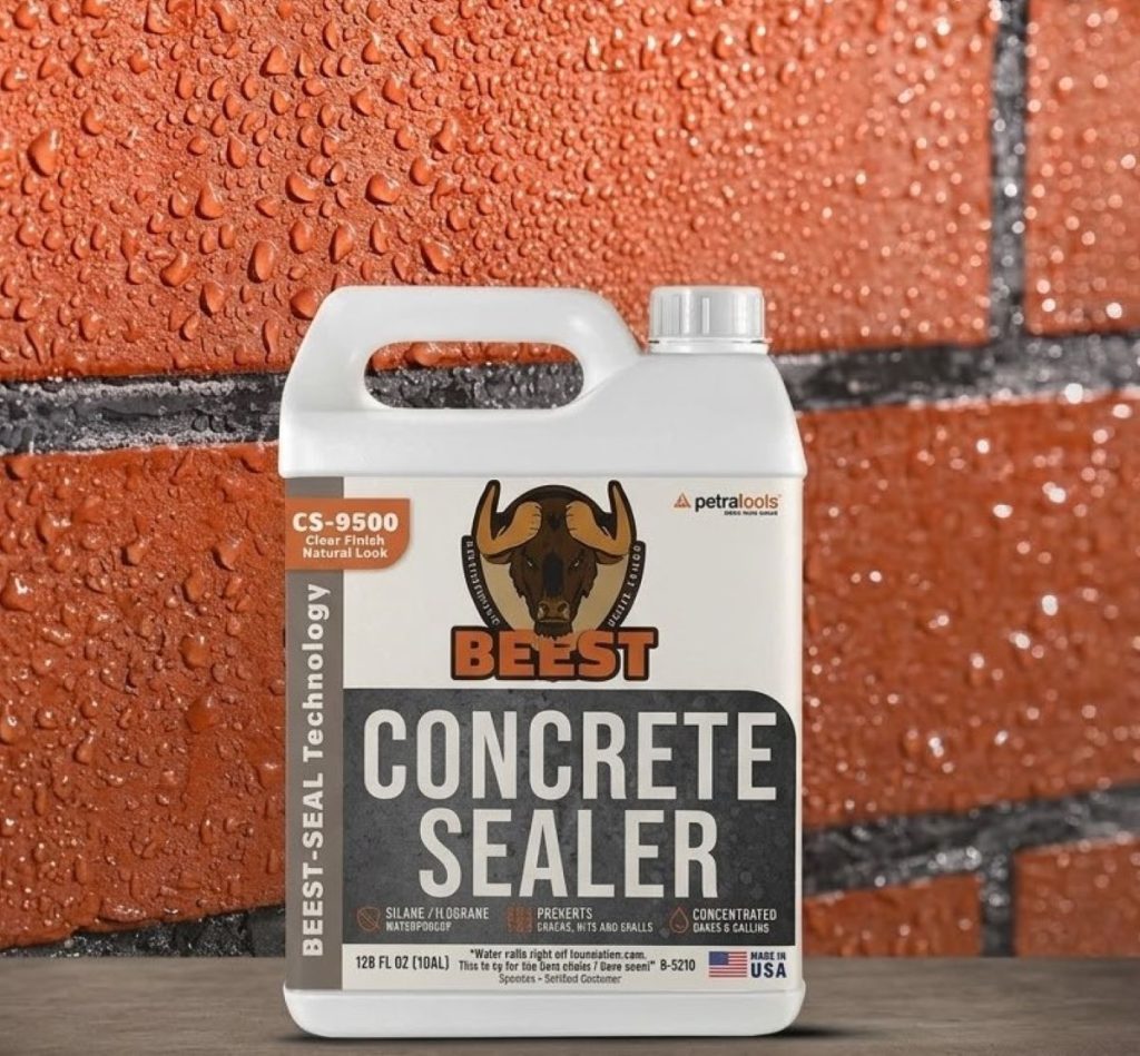 BEEST Concrete Sealer bottle placed on a wooden surface against a waterproofed red brick wall with water droplets.