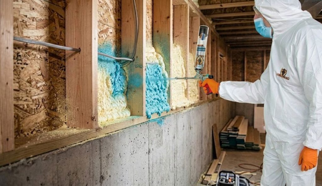 Spray foam insulation applied to rim joist area to seal air leaks.